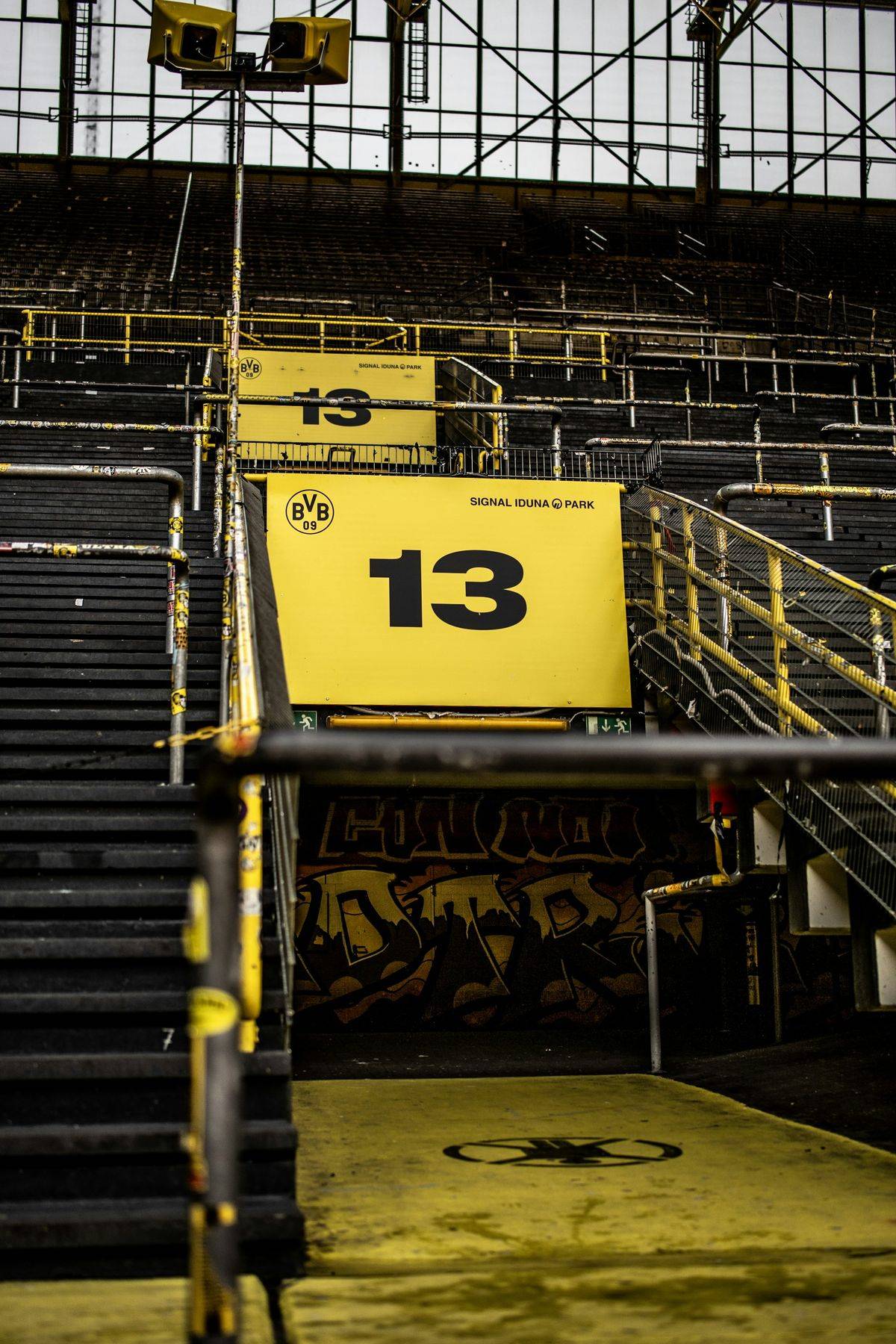 Stairs up to block 13 of the stands at Signal Iduna Park, Borussia Dortmund's stadium, with the yellow BVB sign